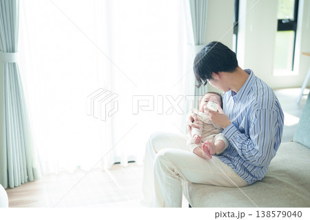 赤ちゃんにミルクを与えるお父さん 138579040
