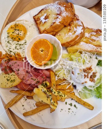 This is a plate of brunch eaten at a cafe. 138580109