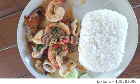 A delicious Thai street food dish of spicy stir-fried shrimp, squid, and mussels with holy basil. 138583086