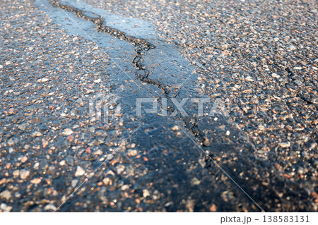 Cracked And Damaged Asphalt Pavement Affected By Weather And Deicing Salt Cracked And Damaged Asphalt Pavement Affected By Weather And Deicing Salt 138583131