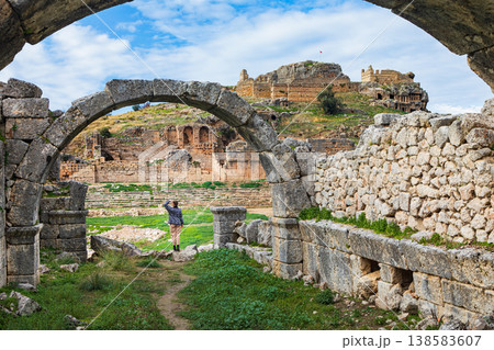 Young child looks at acropolis of ancient Greek city Tlos in Lycia located on Lycian way. Famous historical site In Antalya region. Popular place for family travel on summer vacation. Fethiye, Turkey Young child looks at acropolis of ancient Greek city Tlos in Lycia located on Lycian way. Famous historical site In Antalya region. Popular place for family travel on summer vacation. Fethiye, Turkey 138583607