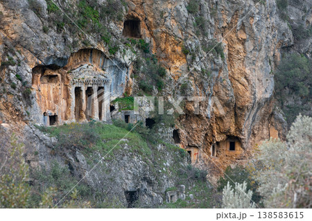 Acropolis, tombs carved in rock of ancient Greek city Tlos in Lycia located on Lycian way. Famous historical site In Antalya region. Popular place for family travel on summer vacation. Fethiye, Turkey Acropolis, tombs carved in rock of ancient Greek city Tlos in Lycia located on Lycian way. Famous historical site In Antalya region. Popular place for family travel on summer vacation. Fethiye, Turkey 138583615