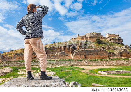 Happy tourist looks at ancient Greek city Tlos in Lycia located on Lycian way. Famous historical site In Antalya region. Popular place for family travel on summer vacation. Fethiye, Turkey Happy tourist looks at ancient Greek city Tlos in Lycia located on Lycian way. Famous historical site In Antalya region. Popular place for family travel on summer vacation. Fethiye, Turkey 138583625