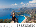 Little girl looking out over Oludeniz beach, Lycia coast. Summer day walk by Lycian way at family vacation in Mediterranean Sea, Fethye, Antalya region, Turkey 138583630