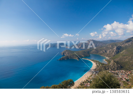 Beautiful view of Oludeniz beach, blue lagoon with turquoise water, Lycia coast from high cliff. Summer day walk by Lycian way at family vacation in Mediterranean Sea, Fethye, Antalya region, Turkey Beautiful view of Oludeniz beach, blue lagoon with turquoise water, Lycia coast from high cliff. Summer day walk by Lycian way at family vacation in Mediterranean Sea, Fethye, Antalya region, Turkey 138583631