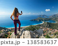 Young woman looking at Oludeniz beach, blue lagoon with clear bright turquoise water, Lycia coast. Summer day walk by Lycian way at family vacation in Mediterranean Sea, Fethye, Antalya region, Turkey 138583637