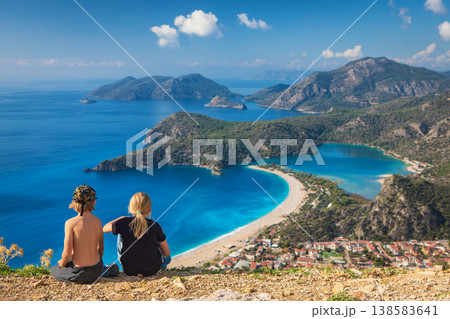Little kids looking at beautiful view Oludeniz beach, blue lagoon, Lycia coast. Summer day walk by Lycian way at family vacation in Mediterranean Sea, Fethye, Antalya region, Turkey 138583641