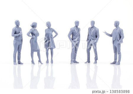 Miniature people figurines grouped together in a modern setting discussing different topics Miniature people figurines grouped together in a modern setting discussing different topics 138583898