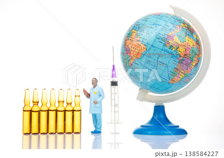 Miniature people interact with medical tools and a globe to show global health themes and science Miniature people interact with medical tools and a globe to show global health themes and science 138584227