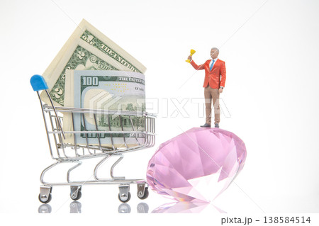 Miniature people with money and treasure on a shopping cart in a simple scene Miniature people with money and treasure on a shopping cart in a simple scene 138584514