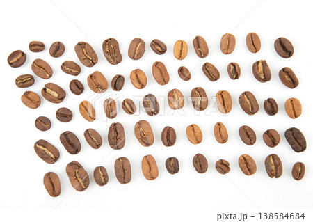 Different types of coffee beans arranged in neat rows on a white surface for display and comparison Different types of coffee beans arranged in neat rows on a white surface for display and comparison 138584684