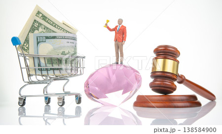 Miniature people showcase money, a trophy, and legal tools in a creative arrangement for a playful  138584900