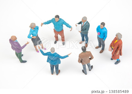 Group of people standing in a circle discussing ideas in a bright setting with white background Group of people standing in a circle discussing ideas in a bright setting with white background 138585489