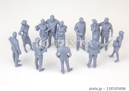 Miniature figurines of people in a group discussion at a meeting in a simple setting Miniature figurines of people in a group discussion at a meeting in a simple setting 138585696