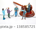 Miniature figurines in a court scene depict a legal process with a judge, a prisoner, 138585725