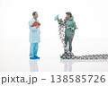 Miniature people interact with a chain and drink in a simple scene showing a meeting of a doctor  138585726