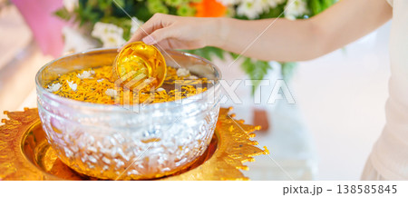Happy Songkran festival day in Thailand or Thai Happy New Year. hand pouring water on golden Buddha statue with flowers and garland in. Holiday and culture concept Happy Songkran festival day in Thailand or Thai Happy New Year. hand pouring water on golden Buddha statue with flowers and garland in. Holiday and culture concept 138585845