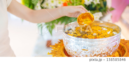 Happy Songkran festival day in Thailand or Thai Happy New Year. hand pouring water on golden Buddha statue with flowers and garland in. Holiday and culture concept Happy Songkran festival day in Thailand or Thai Happy New Year. hand pouring water on golden Buddha statue with flowers and garland in. Holiday and culture concept 138585846
