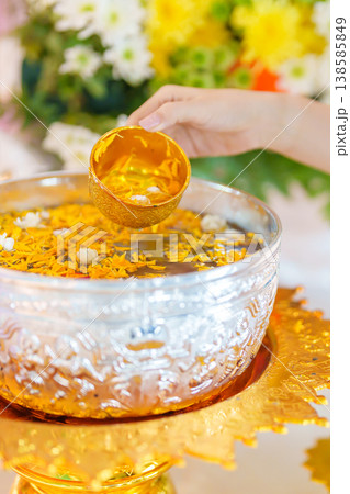 Happy Songkran festival day in Thailand or Thai Happy New Year. hand pouring water on golden Buddha statue with flowers and garland in. Holiday and culture concept Happy Songkran festival day in Thailand or Thai Happy New Year. hand pouring water on golden Buddha statue with flowers and garland in. Holiday and culture concept 138585849