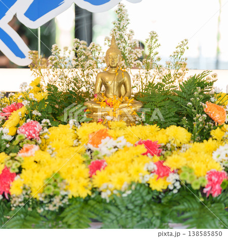 Happy Songkran festival day in Thailand or Thai Happy New Year. hand pouring water on golden Buddha statue with flowers and garland in. Holiday and culture concept Happy Songkran festival day in Thailand or Thai Happy New Year. hand pouring water on golden Buddha statue with flowers and garland in. Holiday and culture concept 138585850