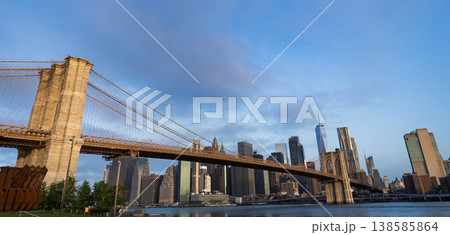 Manhattan cityscape. Amazing scenery of Brooklyn bridge over skyscraper in New York. Architecture of historic bridge in Brooklyn. Way to Manhattan. Brooklyn bridge in New York. Panorama Manhattan cityscape. Amazing scenery of Brooklyn bridge over skyscraper in New York. Architecture of historic bridge in Brooklyn. Way to Manhattan. Brooklyn bridge in New York. Panorama 138585864
