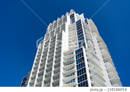Architectural building in Miami beach. Skyscraper perspective view. Hotel architecture. Architecture of modern building. Perspective residential skyscraper. Modern skyscraper building. Bottom view 138586059