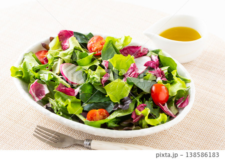 テーブルの上の野菜サラダとオリーブオイル 138586183