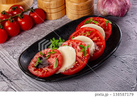 Italian caprese salad with mozzarella, tomato and basil 138587179