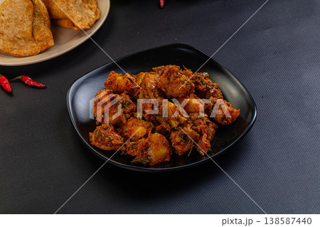 Traditional Indian potato and vegetable curry (Aloo Sabzi) served on a plate with fresh chilis. Traditional Indian potato and vegetable curry (Aloo Sabzi) served on a plate with fresh chilis. 138587440