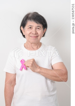 Elderly woman with pink Ribbon for Pink October Breast Cancer Awareness month, May Women Health, August World Breastfeeding week, Nursing Mothers, Pregnancy and Infant Loss Remembrance, Stillbirth 138587531
