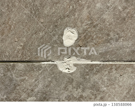 Close Up Of Damaged Porcelain Tile Grout Line With White Repair Mark Close Up Of Damaged Porcelain Tile Grout Line With White Repair Mark 138588066