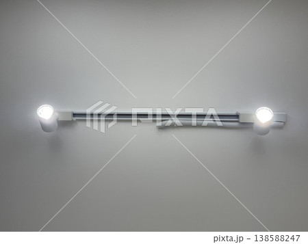 Modern Track Lighting System With Two LED Spotlights On White Wall 138588247