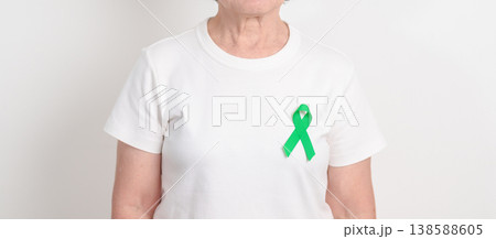 Elderly with Green Ribbon for concept of April Donate Life month, Organ Donation and Transplant Awareness, May Mental Health Awareness month and October Liver cancer. Health and world cancer day Elderly with Green Ribbon for concept of April Donate Life month, Organ Donation and Transplant Awareness, May Mental Health Awareness month and October Liver cancer. Health and world cancer day 138588605