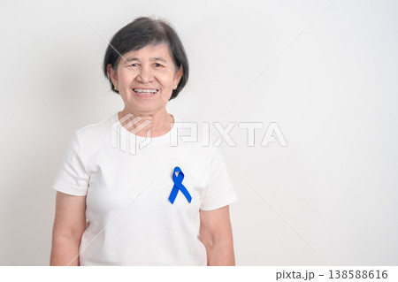 Elderly with dark Blue or Navy blue Ribbon for concept of March Colorectal and Colon Cancer Awareness month, May Arthritis awareness, July Juvenile arthritis and Childhood. Health and world cancer day Elderly with dark Blue or Navy blue Ribbon for concept of March Colorectal and Colon Cancer Awareness month, May Arthritis awareness, July Juvenile arthritis and Childhood. Health and world cancer day 138588616