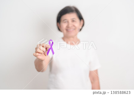 Elderly with Purple Ribbon for Violence, Pancreatic, Esophageal, Testicular cancer, Alzheimer, Epilepsy, Lupus, Crohn, Thyroid,  Sarcoidosis and Fibromyalgia. Awareness month and World cancer day 138588623