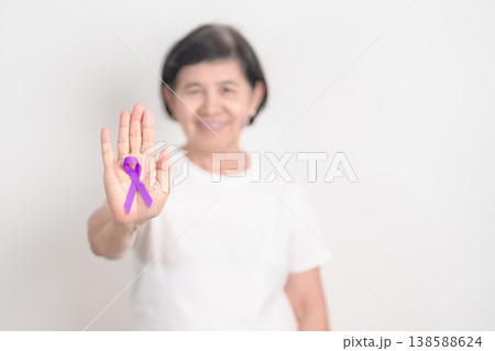 Elderly with Purple Ribbon for Violence, Pancreatic, Esophageal, Testicular cancer, Alzheimer, Epilepsy, Lupus, Crohn, Thyroid,  Sarcoidosis and Fibromyalgia. Awareness month and World cancer day 138588624