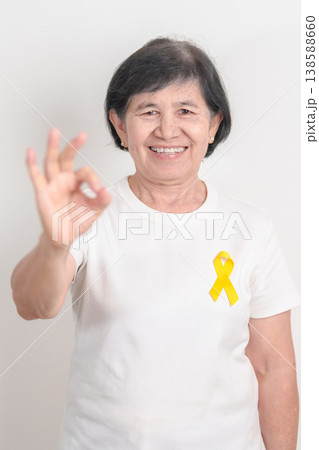 Elderly with Yellow Ribbon for concept of yellow September, Suicide prevention day, Childhood, Pediatric, May Missing Children Awareness day month, support survivor. Healthcare and World Cancer day 138588660