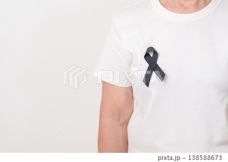 Elderly with Black ribbon for May Melanoma and skin cancer Awareness month, October Vaccine injury awareness month, Mourning Remembrance, March Sleep awareness week, Gang Prevention and Anti Violence 138588673