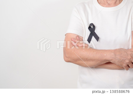 Elderly with Black ribbon for May Melanoma and skin cancer Awareness month, October Vaccine injury awareness month, Mourning Remembrance, March Sleep awareness week, Gang Prevention and Anti Violence 138588676