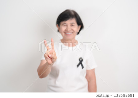Elderly with Black ribbon for May Melanoma and skin cancer Awareness month, October Vaccine injury awareness month, Mourning Remembrance, March Sleep awareness week, Gang Prevention and Anti Violence Elderly with Black ribbon for May Melanoma and skin cancer Awareness month, October Vaccine injury awareness month, Mourning Remembrance, March Sleep awareness week, Gang Prevention and Anti Violence 138588681