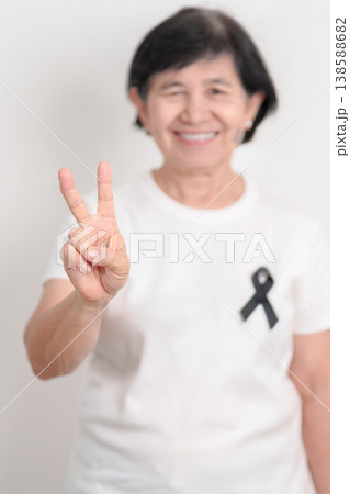 Elderly with Black ribbon for May Melanoma and skin cancer Awareness month, October Vaccine injury awareness month, Mourning Remembrance, March Sleep awareness week, Gang Prevention and Anti Violence Elderly with Black ribbon for May Melanoma and skin cancer Awareness month, October Vaccine injury awareness month, Mourning Remembrance, March Sleep awareness week, Gang Prevention and Anti Violence 138588682