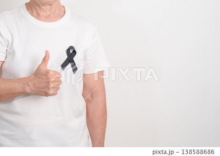 Elderly with Black ribbon for May Melanoma and skin cancer Awareness month, October Vaccine injury awareness month, Mourning Remembrance, March Sleep awareness week, Gang Prevention and Anti Violence 138588686