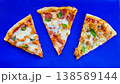 Pepperoni Pizza Slices on Blue Background Top View 138589144