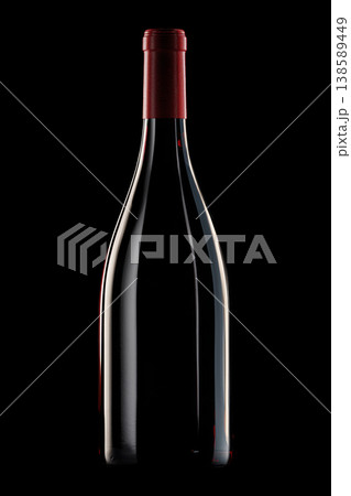 A dark glass wine bottle with foil cap isolated on black background with clipping path, symbolizing elegance and celebration 138589449