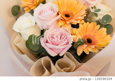 Soft pastel bouquet of pink roses and orange gerbera flowers with eucalyptus leaves. Soft pastel bouquet of pink roses and orange gerbera flowers with eucalyptus leaves. 138590104