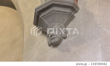 Stone carved human face detail on gothic column inside Malbork Castle in Poland. Architecture, history and heritage concept 138590482