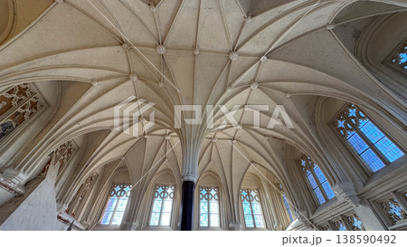 Wide view of gothic hall with complex ribbed vault ceiling tall windows and central column in Malbork Castle Poland. Architecture, heritage and historic interior concept 138590492