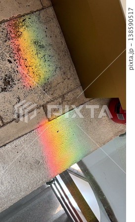 Rainbow light reflection on stone surface inside historic building creating colorful spectrum pattern. Light, color and texture concept Rainbow light reflection on stone surface inside historic building creating colorful spectrum pattern. Light, color and texture concept 138590517