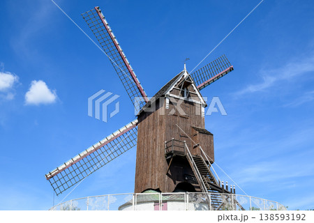 Traditional wooden windmill under blue sky Traditional wooden windmill under blue sky 138593192