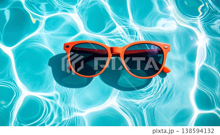 Sunglasses Floating on Blue Pool Water Sunglasses Floating on Blue Pool Water 138594132
